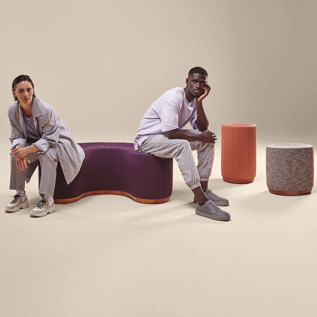 "Stylish seating in purple and soft pastel hues with textured patterns, complemented by neutral-toned accessories."