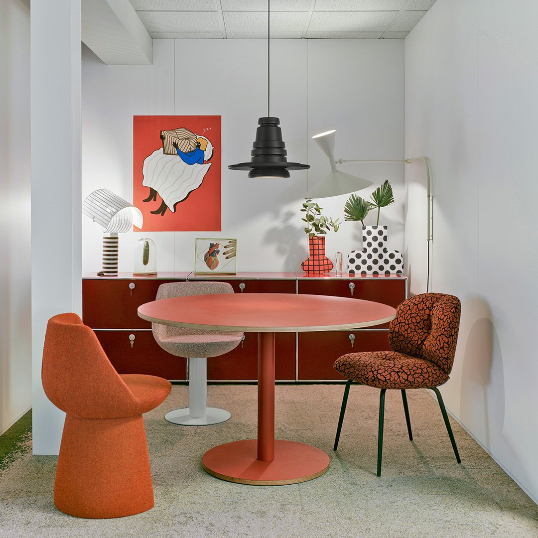 Modern dining space featuring vibrant orange, muted gray, and bold black-and-white patterns.