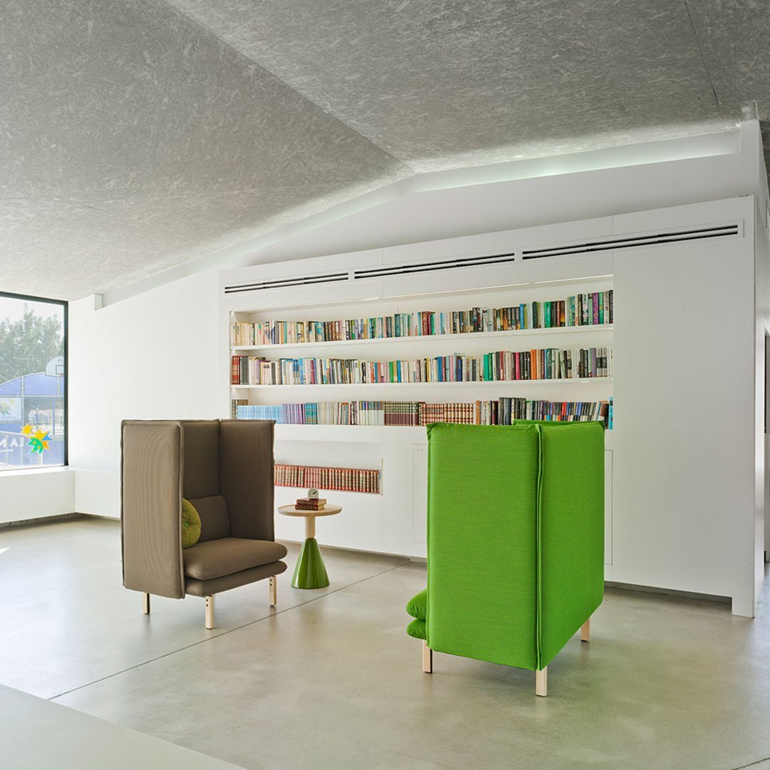 "Modern brown and green seating with sleek lines in a bright, minimalistic interior setting."