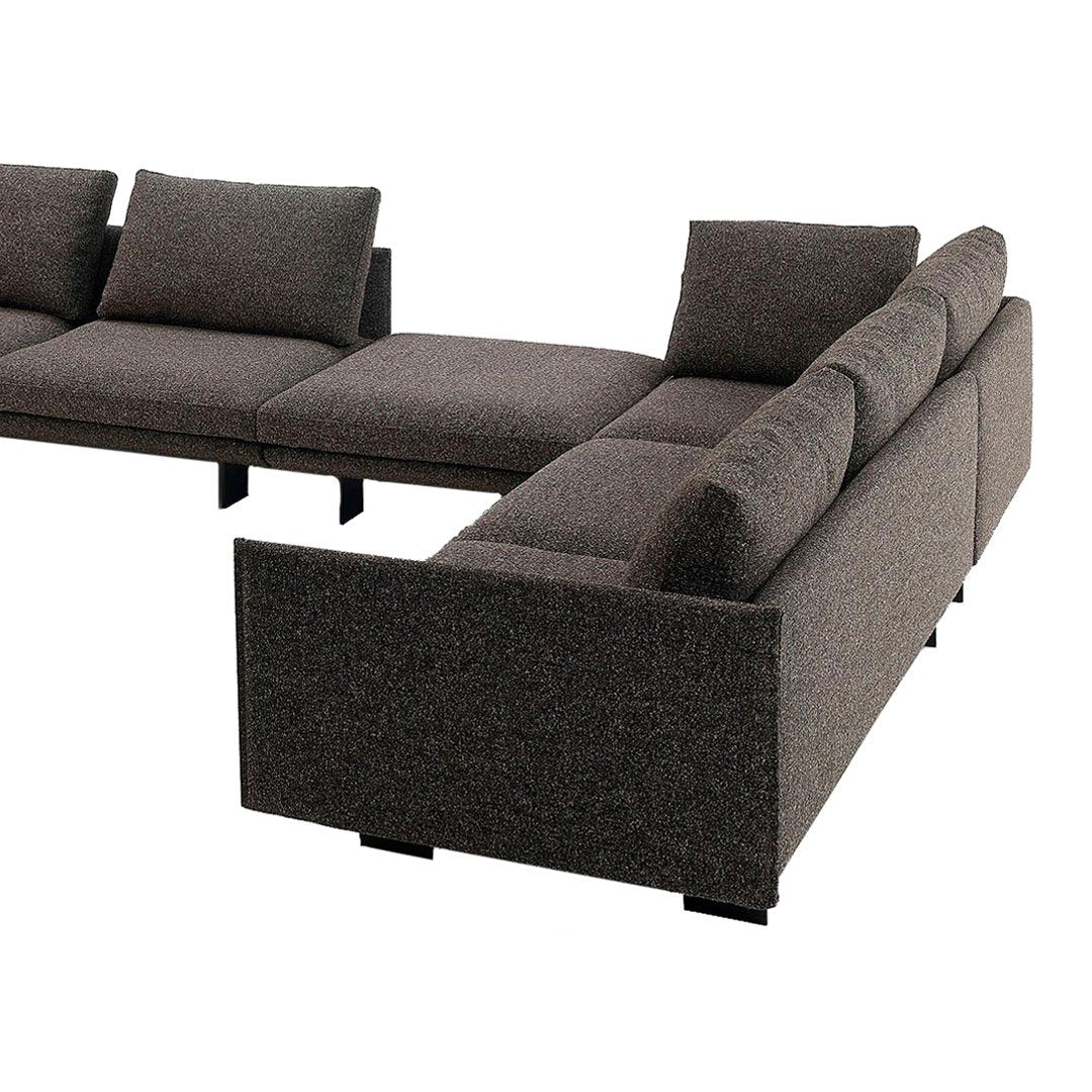 Dark gray sectional sofa with textured upholstery and sleek black legs. Modern design with minimalist aesthetic.