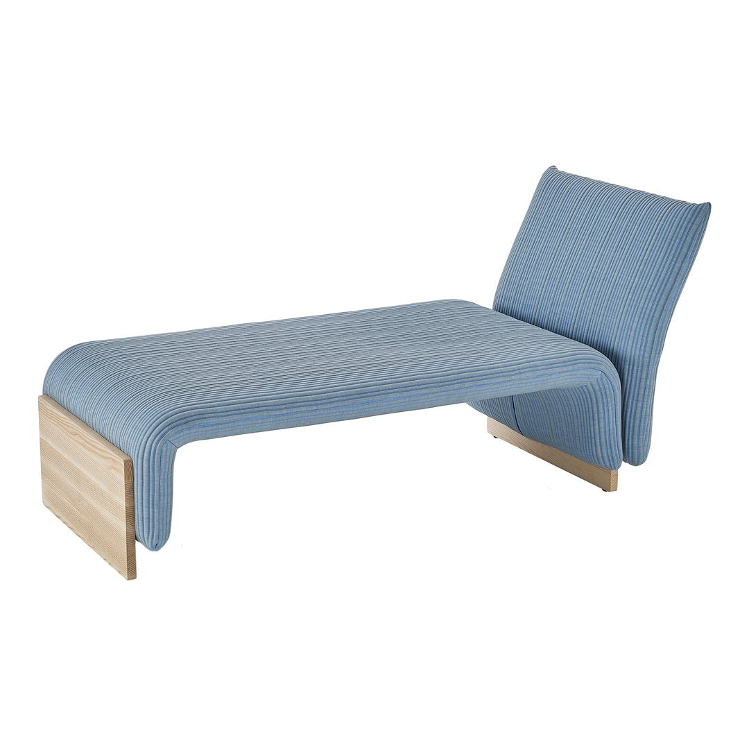 Light blue upholstered chaise lounge with subtle ribbed pattern and natural wood accents. Perfect for modern decor.