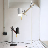 Modern floor lamps in black, white, and gold accents with sleek designs and minimalistic patterns, perfect for any decor.