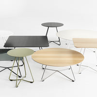 Collection of modern coffee tables in black, white, olive green, and natural wood finishes with various sleek patterns.