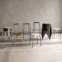 "Stylish wooden and metal bar stools in natural wood, black, and white finishes, featuring minimalist design and stacked patterns."