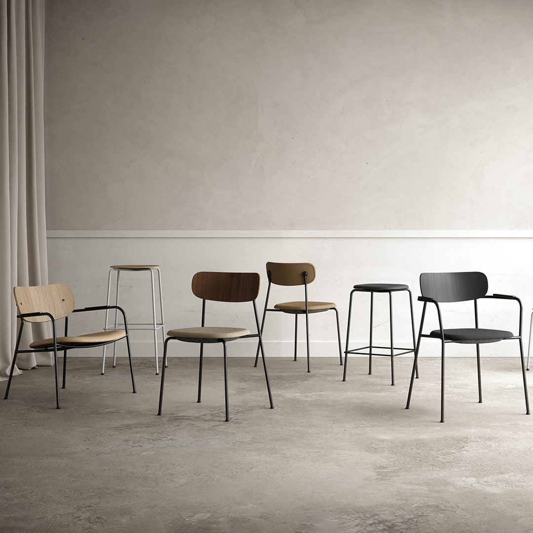 Set of six minimalist chairs featuring natural wood tones and sleek black metal accents on a neutral background.