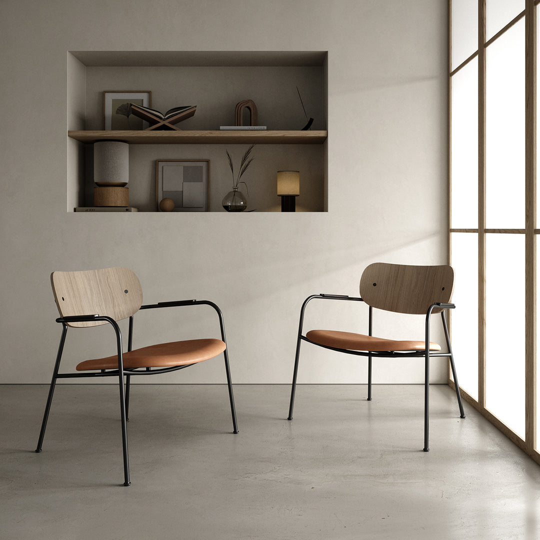 Modern two-tone chairs featuring a light wood backrest and warm brown seat on a sleek black frame.