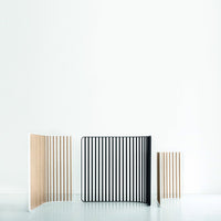 Wooden dividers in natural wood and bold black stripes, showcasing modern minimalism and clean lines.