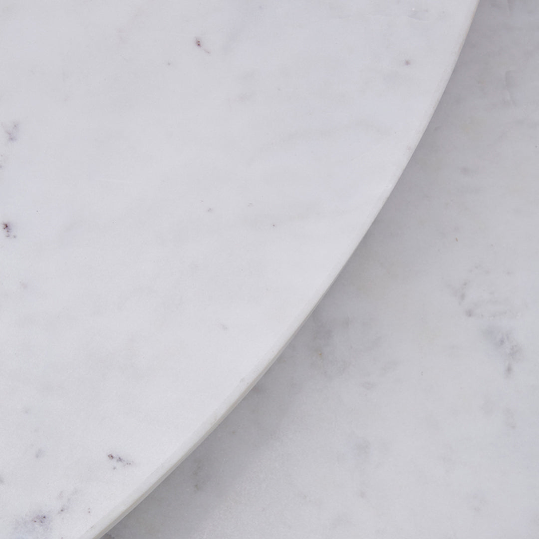 White marble surface with subtle grey veining, showcasing smooth, polished patterns and elegant finish.