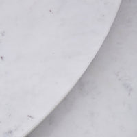 White marble surface with subtle grey veining, showcasing smooth, polished patterns and elegant finish.