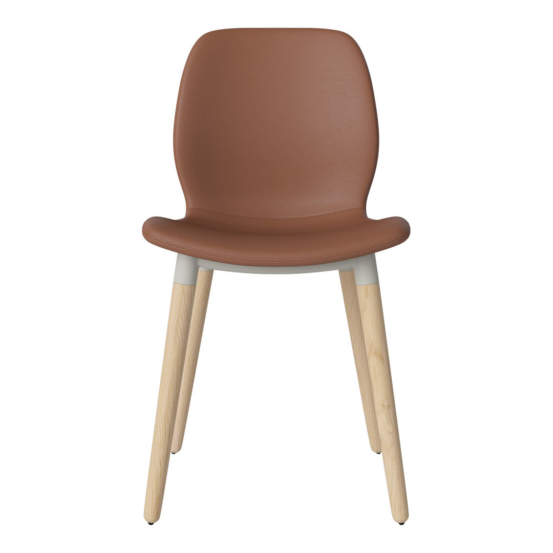 Brown faux leather chair with light wooden legs and a minimalist design, perfect for modern interiors.