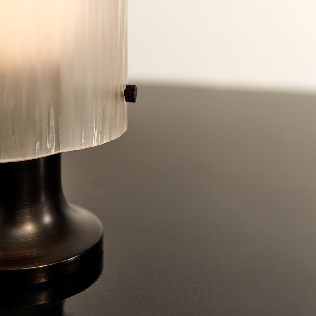 Black base with clear ribbed glass shade, showcasing a modern and elegant design. Ideal for contemporary decor.