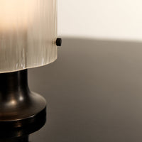 Black base with clear ribbed glass shade, showcasing a modern and elegant design. Ideal for contemporary decor.