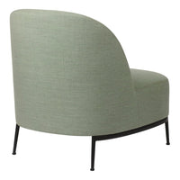 Curved accent chair in soft green fabric with subtle texture, featuring sleek black metal legs.