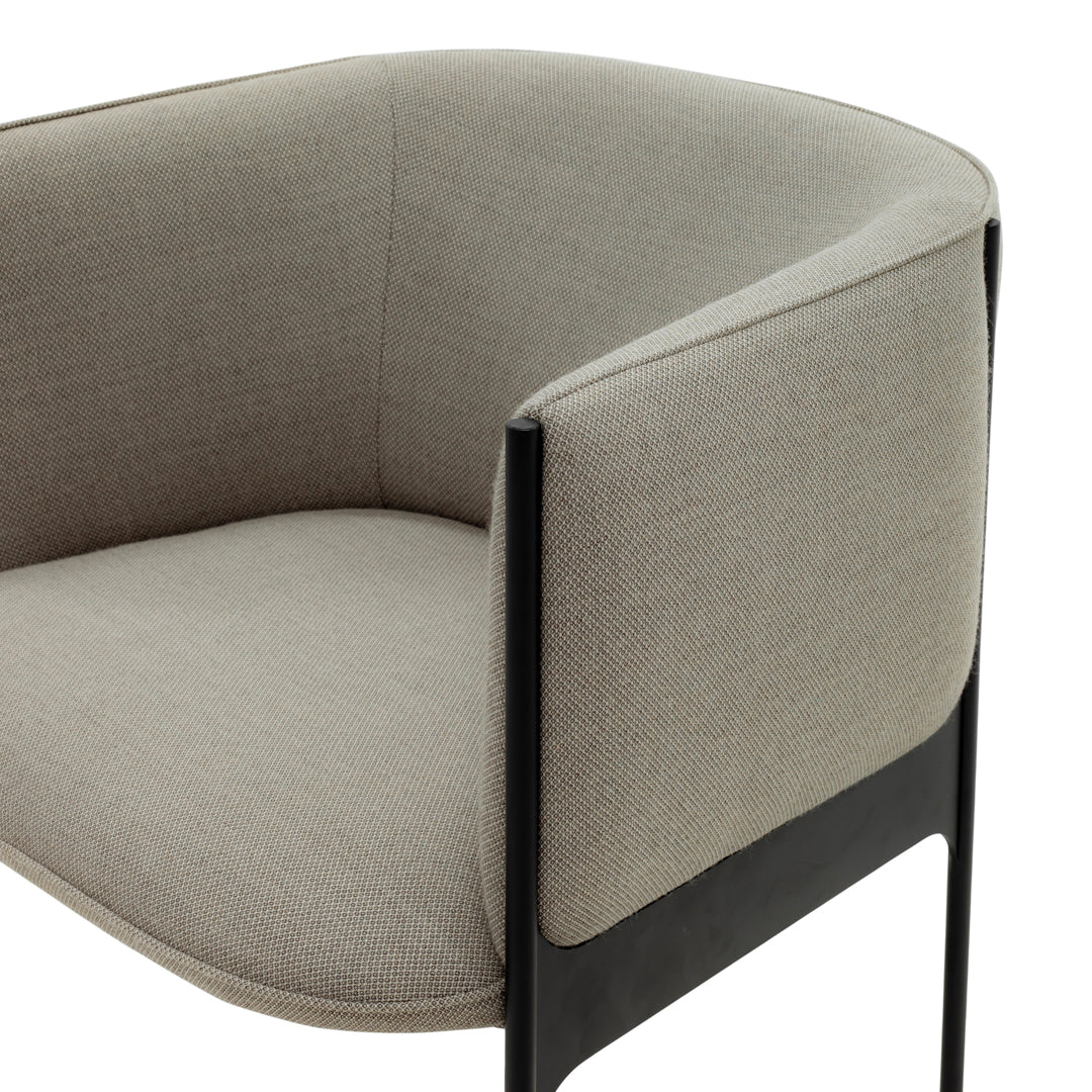Light gray upholstered chair with a smooth texture and sleek black metal legs, showcasing a modern design.