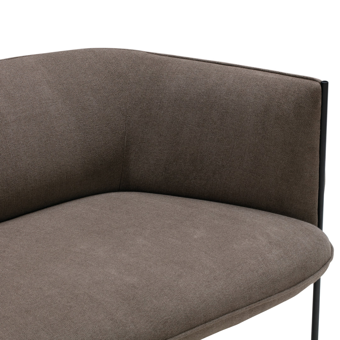 Brown fabric upholstery with a smooth texture and minimalist black metal legs. Elegant and modern design.