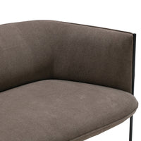 Brown fabric upholstery with a smooth texture and minimalist black metal legs. Elegant and modern design.