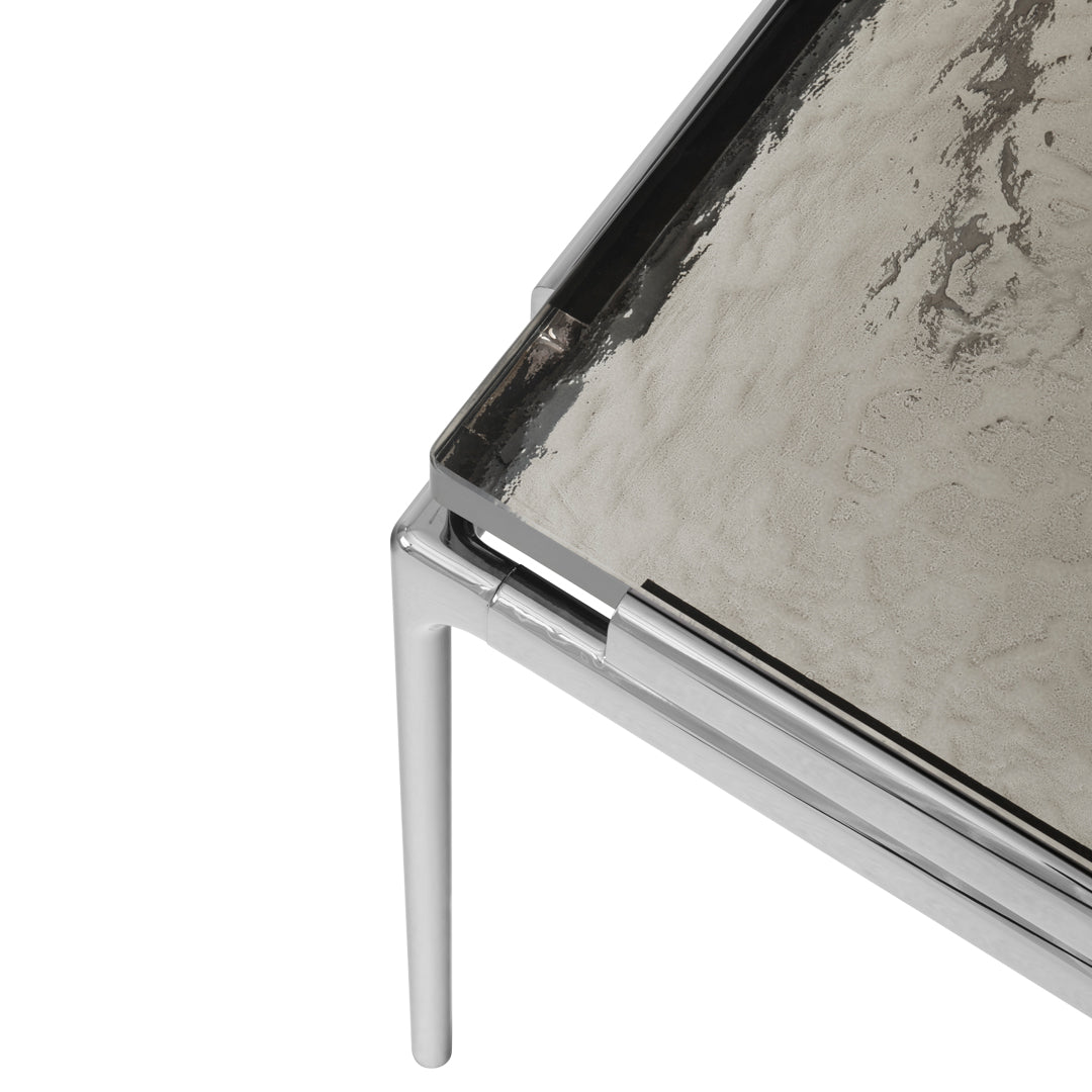 Sleek silver chrome legs with a textured, reflective silver tabletop pattern. Modern and stylish design.