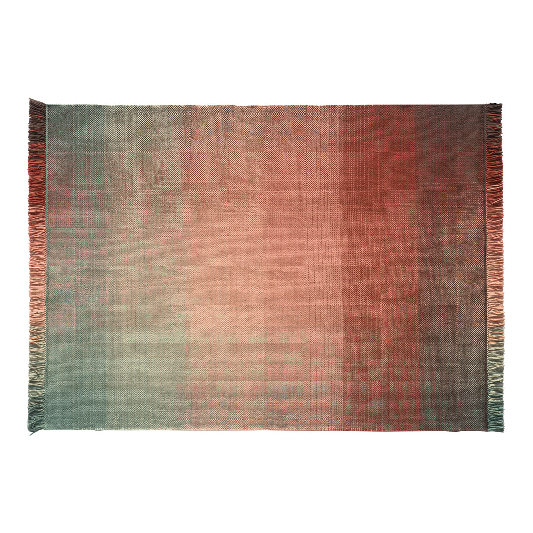 Ombre rug featuring soft hues of peach, coral, and teal with fringed edges for a stylish, contemporary look.