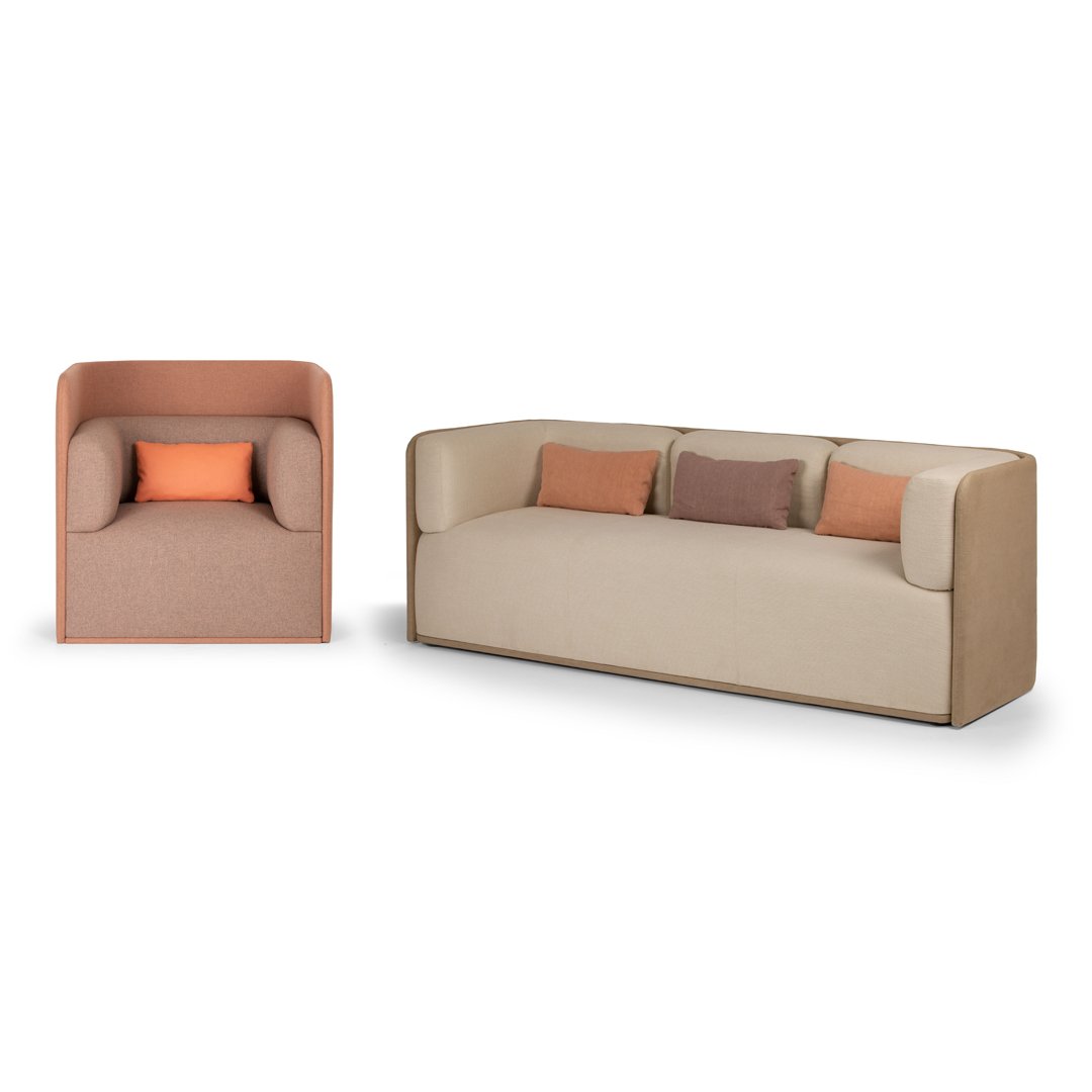 Beige and soft pink sofa set with contrasting square cushions in earthy tones. Modern, minimalist design.