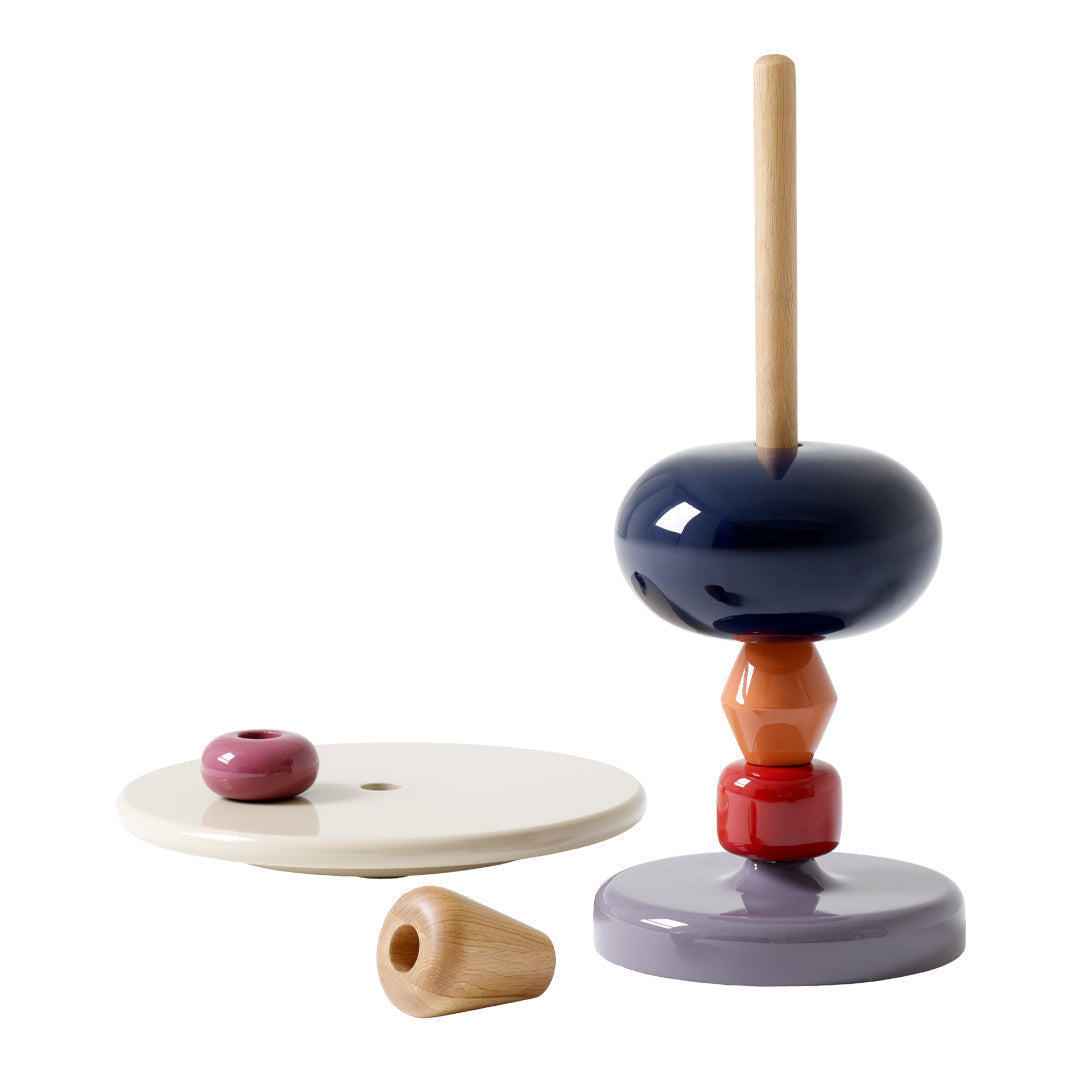 Colorful stacking toy featuring deep navy, peach, cream, and rustic red patterns. Perfect for playful decor.