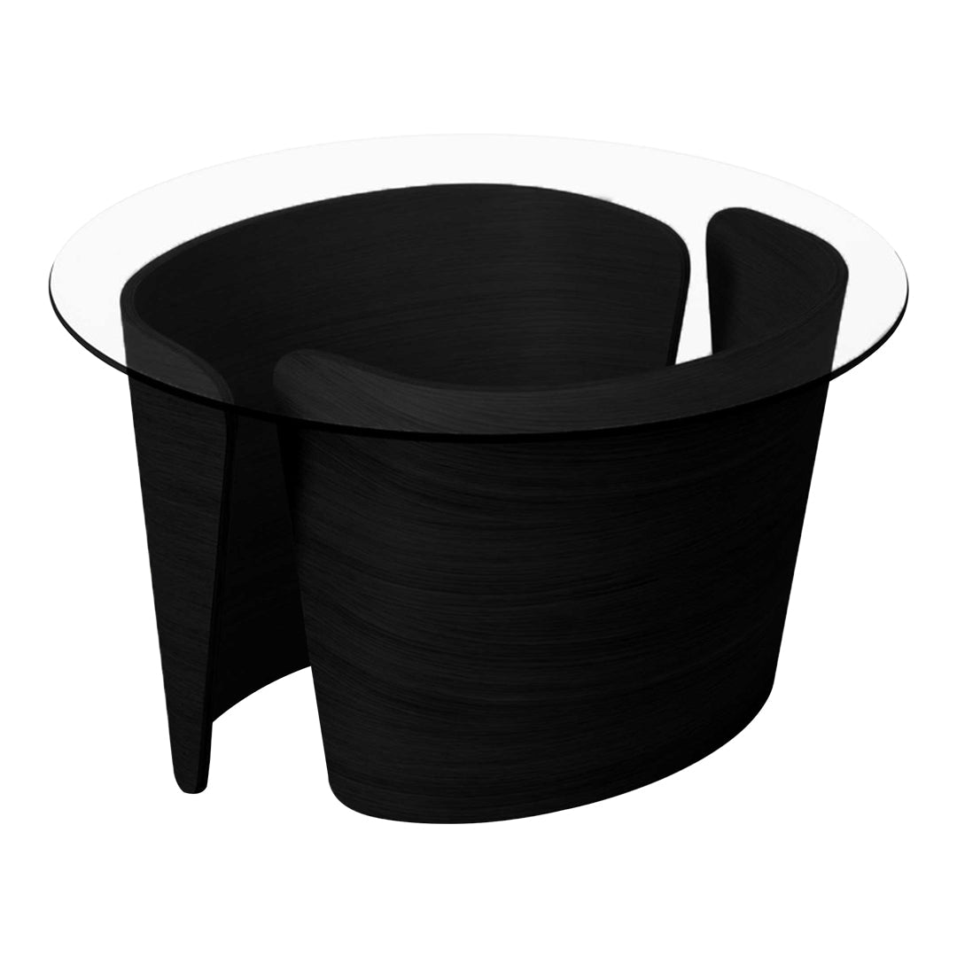 Black sculptural table with a clear glass top, featuring smooth, curved lines and a modern design.
