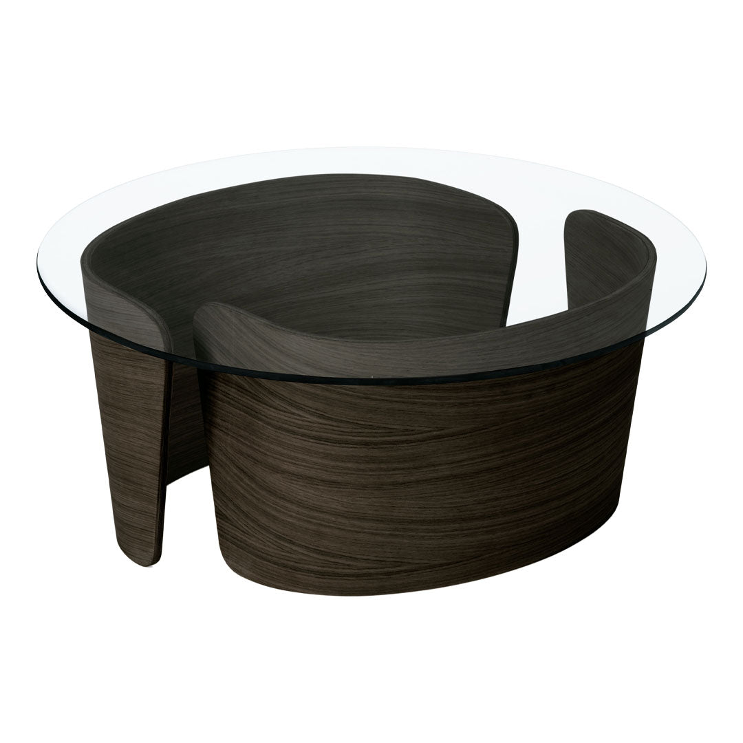 Modern round coffee table with a sleek glass top and a textured dark wood base in a unique curved design.