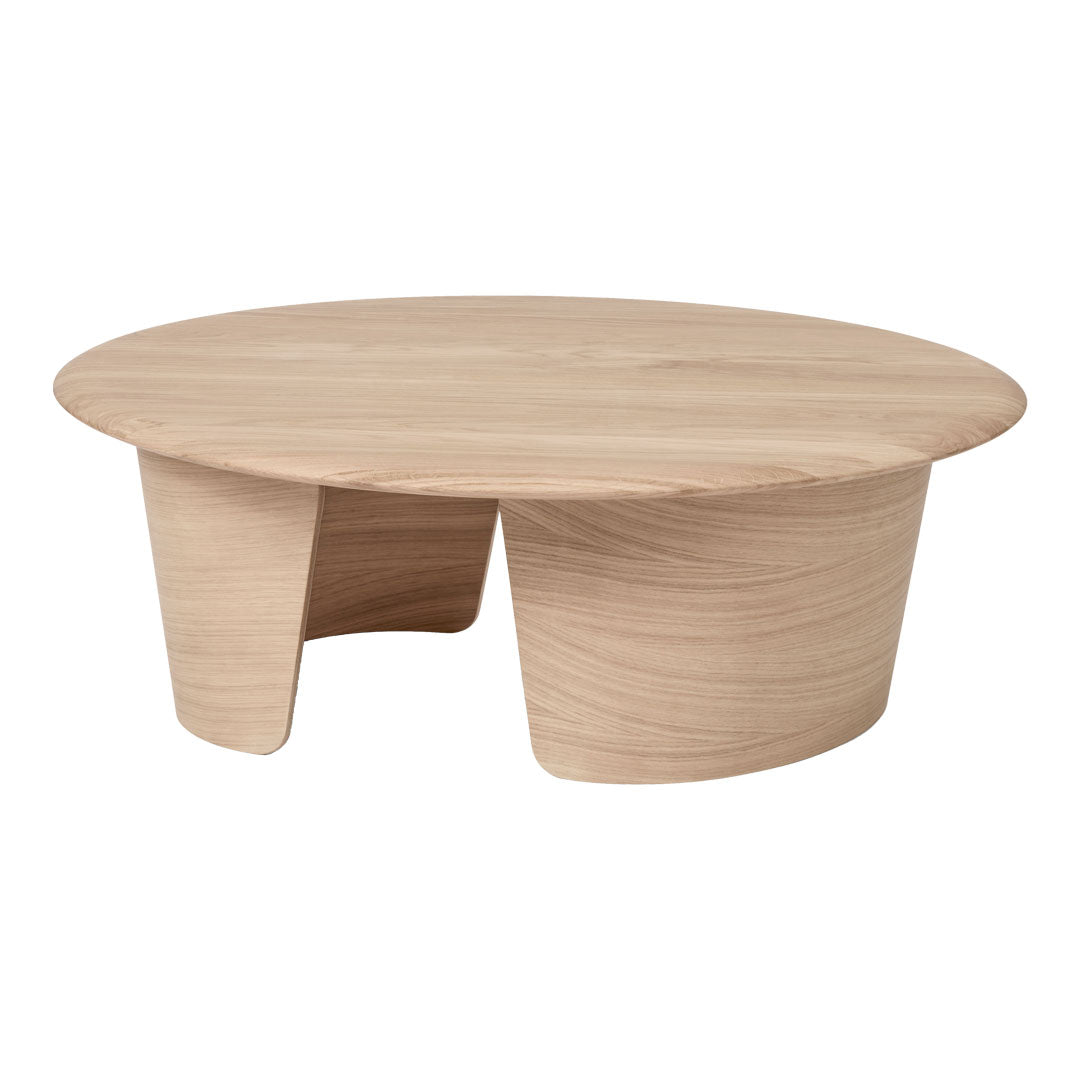 Light wood round coffee table with smooth surface and curved base, showcasing a natural, minimalist design.