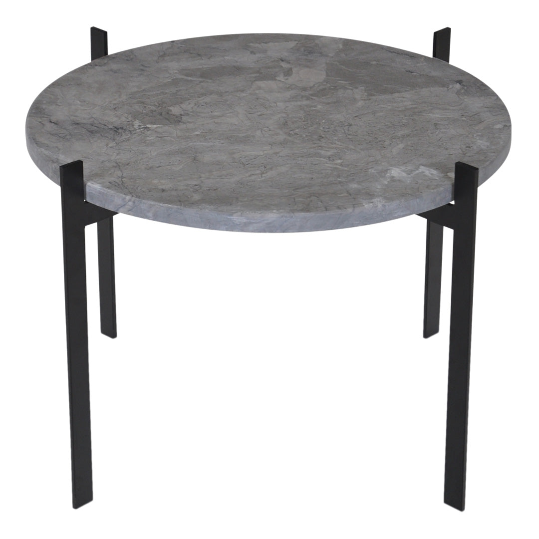 Round table with a textured gray marble top and sleek black metal legs. Modern design perfect for any decor.