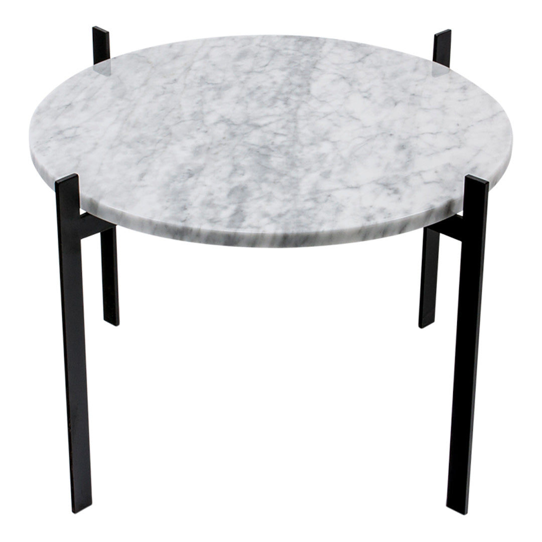 Round marble table with a sleek gray surface and contrasting black metal legs, perfect for modern decor.