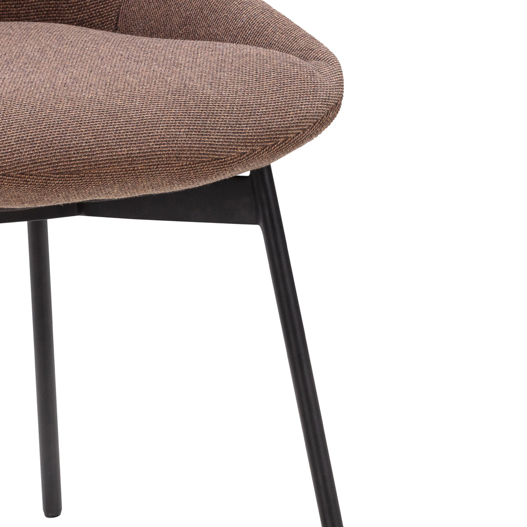 Brown fabric chair with a smooth texture and sleek black metal legs. Modern design for contemporary interiors.