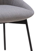 Gray upholstered chair with a smooth, rounded seat and sleek black legs, showcasing a minimalist design.
