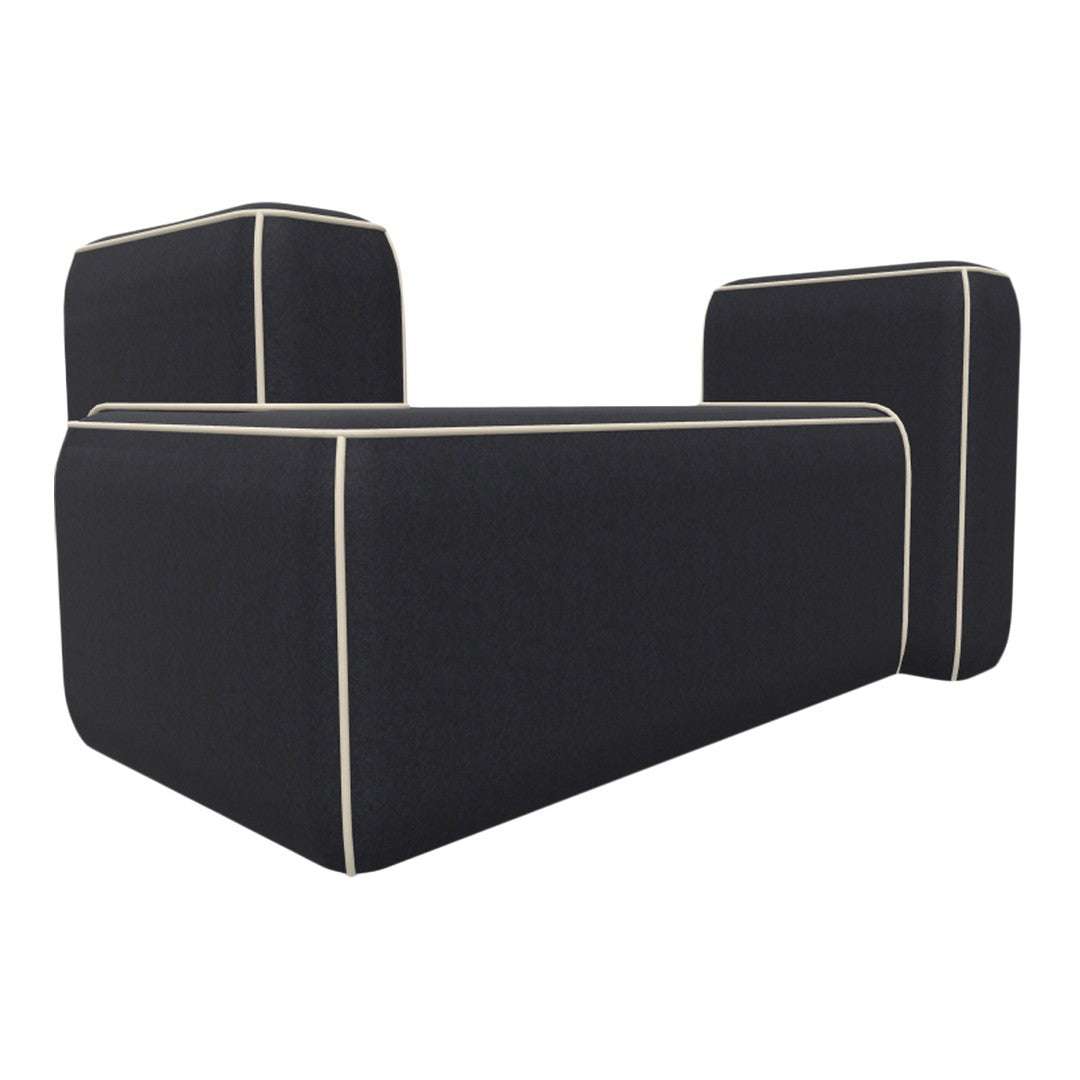 Black sofa with cream piping detail, featuring a modern, minimalistic design and geometric shape.