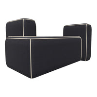 Black sofa with cream piping detail, featuring a modern, minimalistic design and geometric shape.