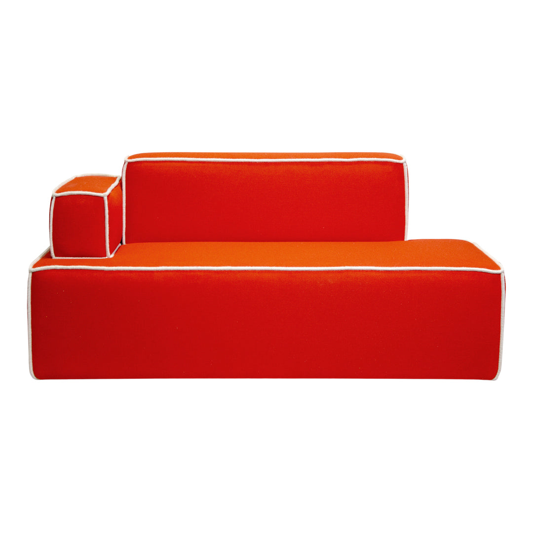 Bright red sofa with contrasting white piping and a modern, geometric design. Perfect for bold decor.