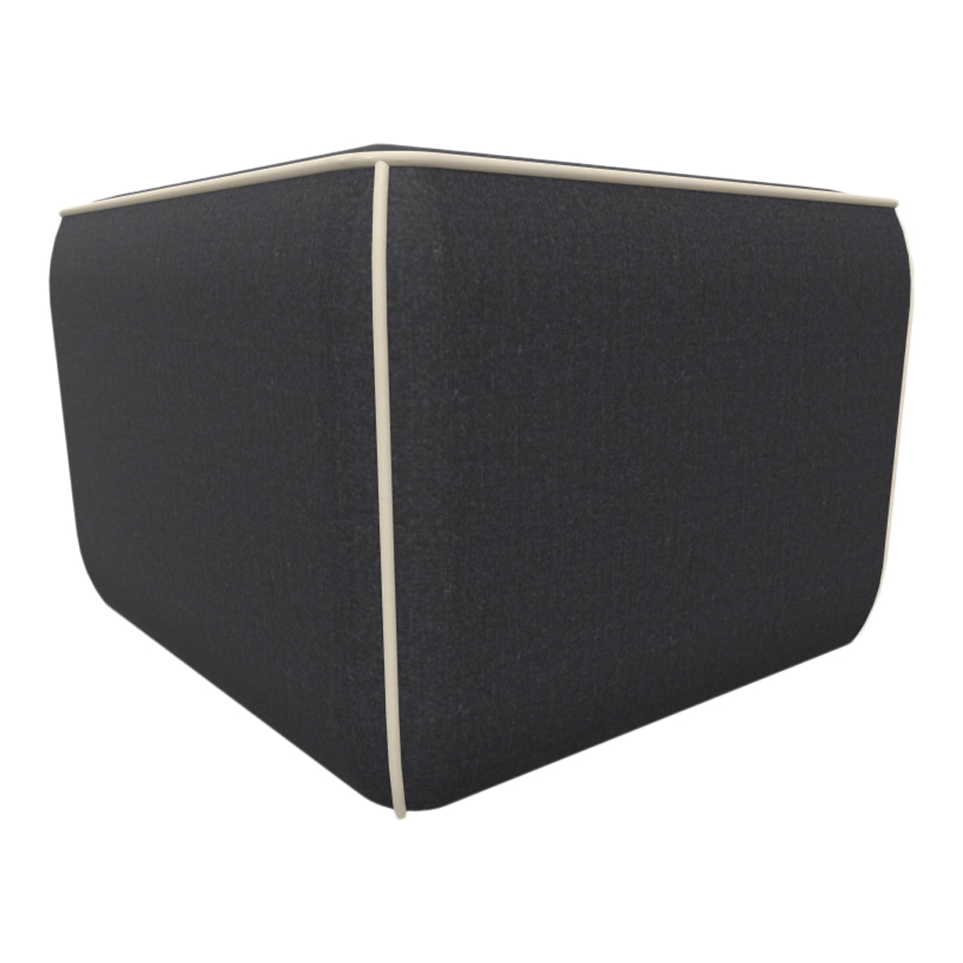 Dark gray cube ottoman with cream piping detail, featuring a textured fabric finish. Ideal for modern decor.