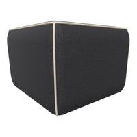 Dark gray cube ottoman with cream piping detail, featuring a textured fabric finish. Ideal for modern decor.