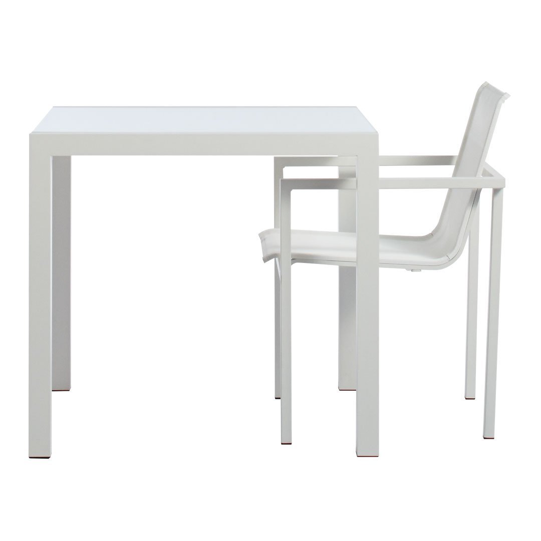 White minimalist square table with a matching translucent chair, featuring a clean, modern design and smooth surfaces.