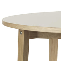 Light gray round tabletop with natural wood legs, showcasing a minimalist and modern design.
