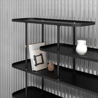 Sleek black shelving unit with smooth surfaces, minimalist design, and a subtle vertical striped background.