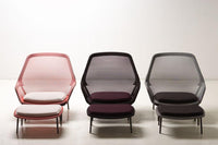 "Three modern chairs in blush pink, deep purple, and charcoal gray with sleek mesh backs and cushioned seats."