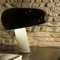 Glossy black lamp shade with a sleek white marble base, blending modern design with elegant colors and smooth textures.