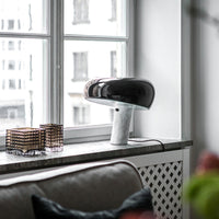 Stylish black and white lamp with smooth curves and a matte finish, complementing a modern interior design.