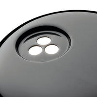 Black round surface with three white circular cutouts, creating a sleek and modern look.