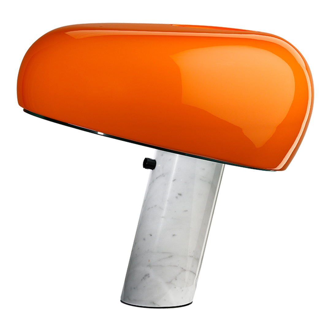 Orange modern lamp with a glossy finish and a sleek white marble base. Contemporary design for stylish interiors.