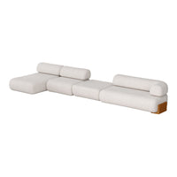 Cream-colored modular sofa with rounded edges and textured fabric, featuring natural wood accents.