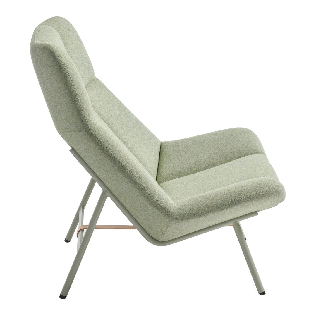 Light green upholstered chair with sleek lines and minimalist design on a white background.
