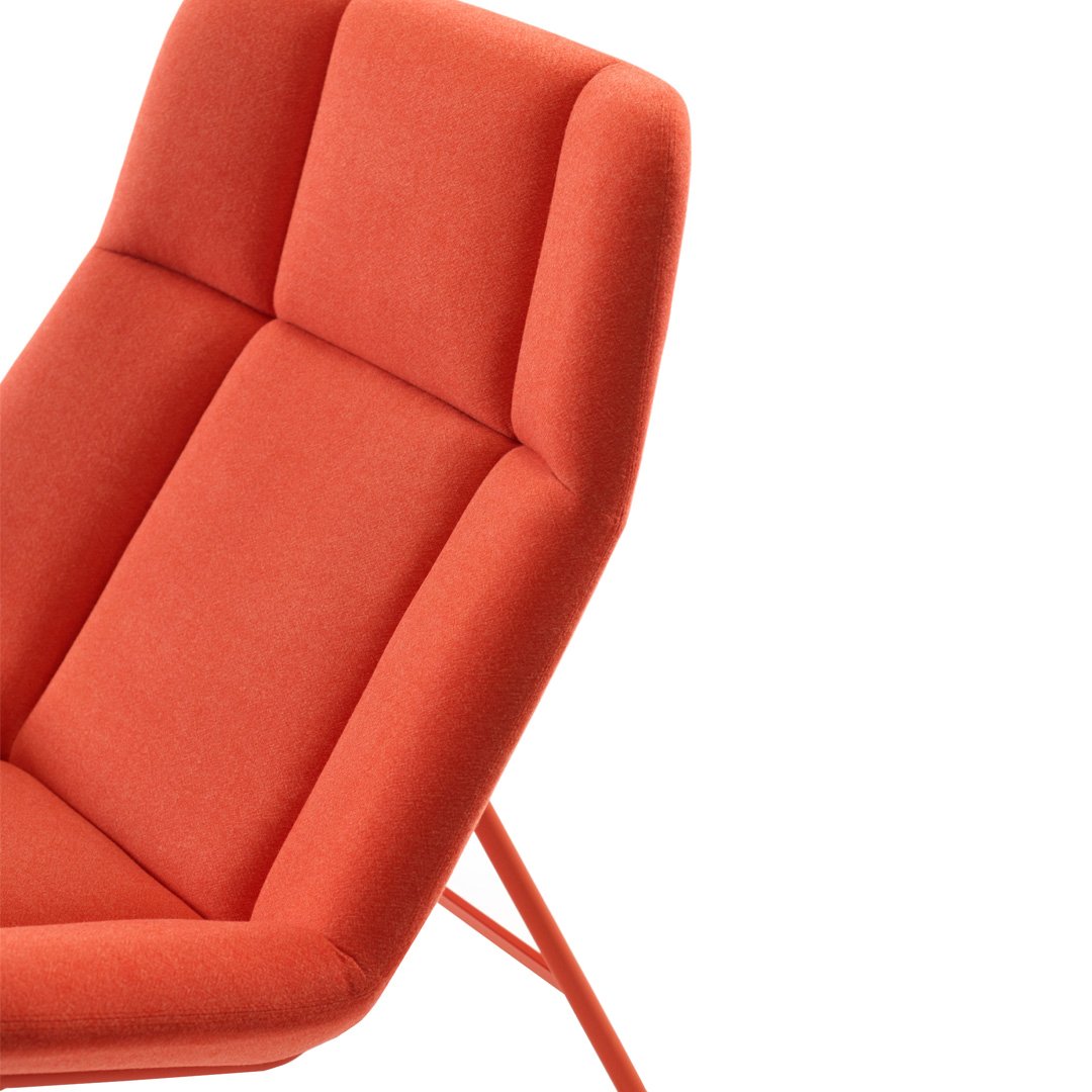 Vibrant orange upholstered chair with sleek geometric pattern and smooth textures, perfect for modern decor.