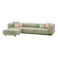Light green sectional sofa with soft pink accent pillows, featuring a modern, sleek design. Perfect for contemporary living spaces.