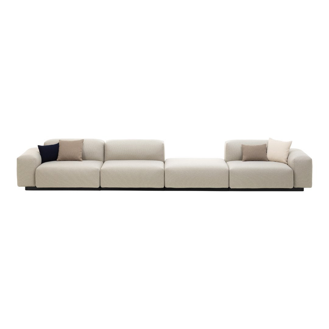 Beige sectional sofa featuring subtle texture and soft accent pillows in muted tones. Modern minimalist design.