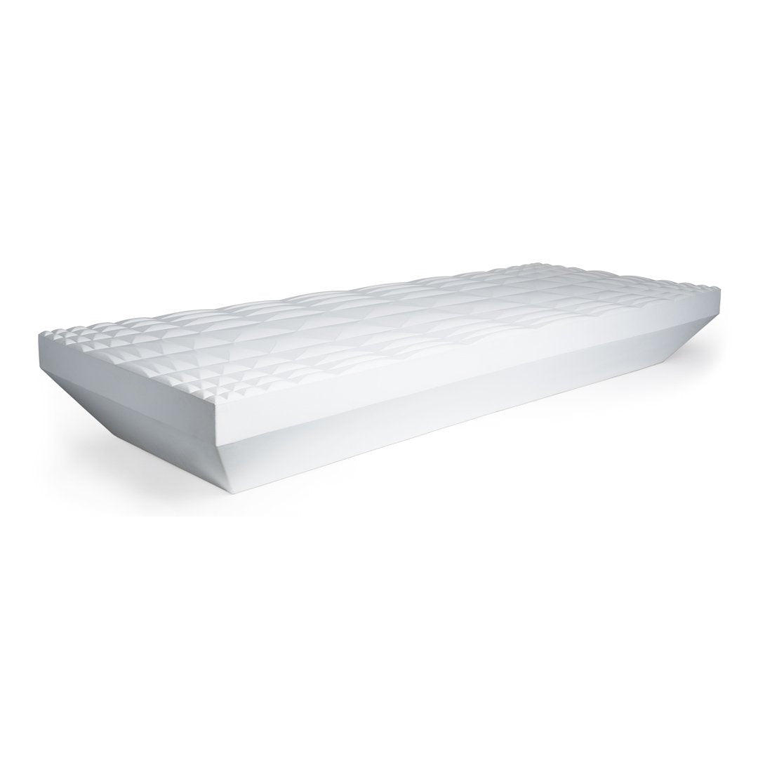 White mattress with a textured, geometric pattern on top, showcasing a clean and modern design.